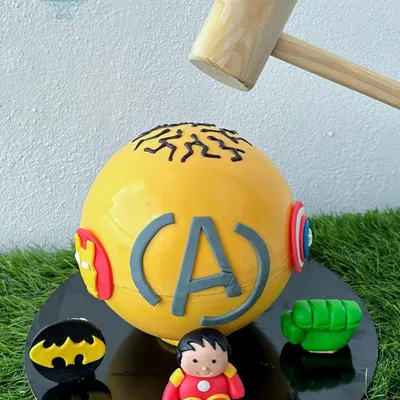 This Avengers-themed pinata cake was made for a young superhero fan named Avyaan. We included all his favorite hero logos on the chocolate shell, ready to be smashed open to reveal a treasure trove of candy.