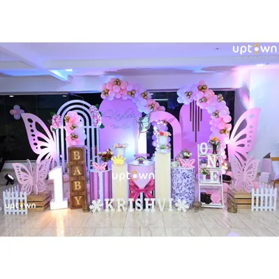 A beautiful butterfly theme for Krishvi's first birthday, using shades of purple and pink with large butterfly wing cutouts.