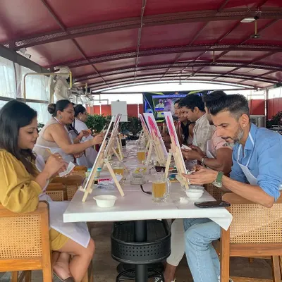 A perfect setup for a weekend paint session. We line up the easels, paints, and drinks so you can just settle in and get creative. This is your chance to break from the routine and make some art.