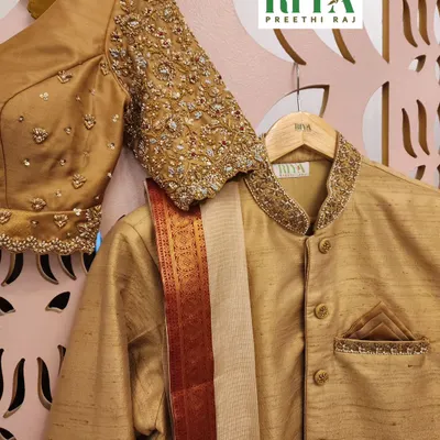 A perfect pair for their wedding day. This set includes the bride's golden Muhurtham blouse with intricate sleeve work and the groom's coordinated ethnic kurta. Designing for couples is a joy, as we create a visual story of their union.