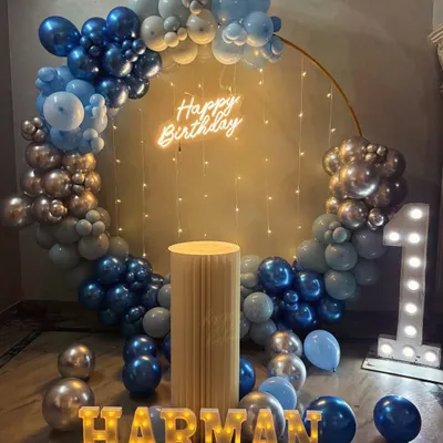 A baby's first birthday is always a precious milestone. For Harman's big day, we designed this beautiful blue and silver setup with a full balloon ring, a light-up number '1', and his name in glowing marquee letters.