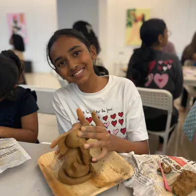 The joy of handmade creation is written all over her face! This participant is deeply immersed in sculpting her own clay Ganesha during our workshop, a truly heartfelt connection to the festival.