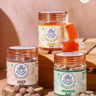 Our classic trio for every craving. This shot features our tangy Imly Candy, sweet Orange Aam Papad, and chewy Dried Mango Slices, each offering a distinct taste of home.