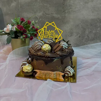 My bestseller, the Belgian Chocolate and Strawberry cake. This rich chocolate drip cake is topped with chocolate covered strawberries, Ferrero Rocher, and KitKat pieces.