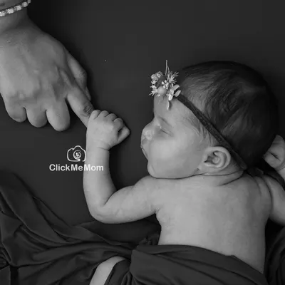 The moment your baby's tiny hand wraps around your finger is pure magic. In black and white, this simple gesture becomes a powerful symbol of your new bond.