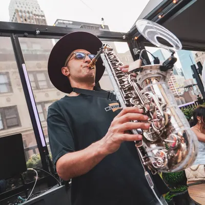 The magic of a live saxophone layered over my DJ set during a sundowner in New York City. This fusion creates a sophisticated and soulful vibe.