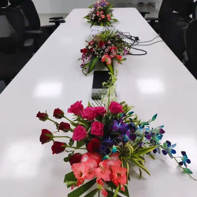 Even in a formal setting like a conference room, details matter. I provide custom floral centerpieces like these, designed to add color and life to the table without obstructing views during meetings.