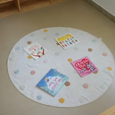 Our reading nook is a cozy and inviting space for children to relax with a book. I carefully select age-appropriate stories that are displayed on a soft mat, encouraging children to explore them independently.