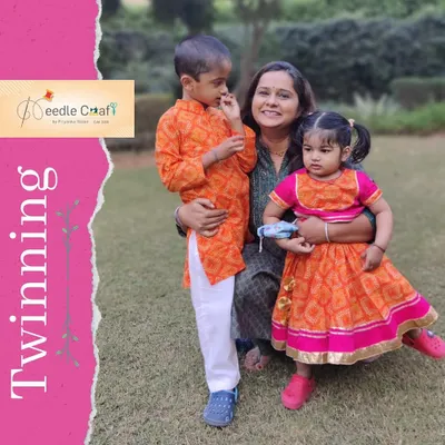 This brother-sister ethnic set was designed for a festive celebration. The boy's vibrant orange bandhani print kurta perfectly complements his sister's matching lehenga, creating a bright and joyful look.