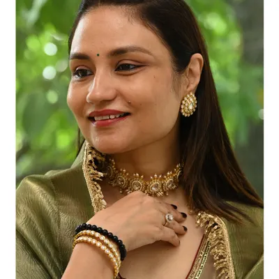 A client finds her perfect match, pairing our heritage-inspired choker and earrings with her elegant attire during a private jewelry viewing at our Gurgaon studio.