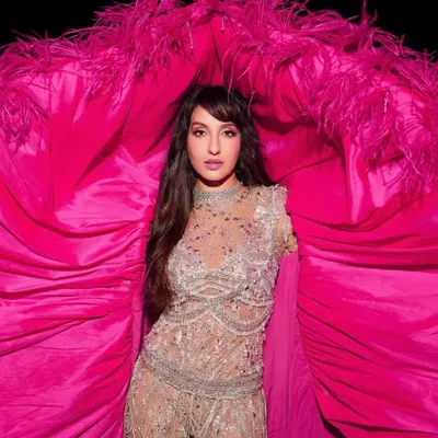 A close-up of Nora Fatehi's FIFA World Cup 2022 performance look. The intricate beading on the Falguni Shane Peacock India catsuit and the vibrant pink cape were chosen for their stunning visual effect under stage lights.
