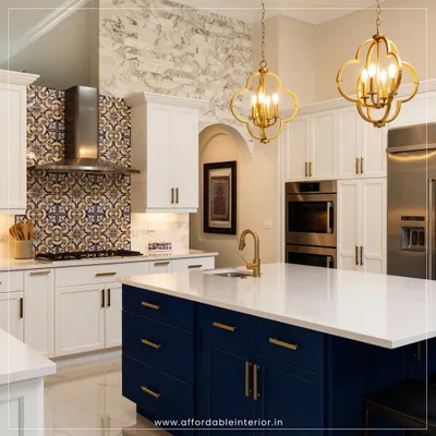 This luxurious kitchen design features a stunning blue island with white countertops, complemented by intricate backsplash tiles and elegant gold pendant lights.