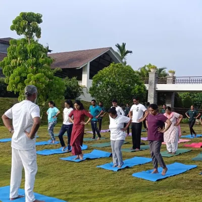 An outdoor yoga session in progress, led by our experienced instructor. Practicing on the soft grass with a view of the hills allows our guests to deeply connect with nature and their own bodies.