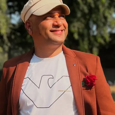 A candid portrait of me, taken outdoors. I believe an artist's work is a reflection of their soul and their connection to the world around them.