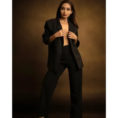 A powerful fashion statement with a classic power suit. I used a warm, painterly backdrop to contrast with the sharp, modern tailoring, creating a look suitable for a magazine editorial.
