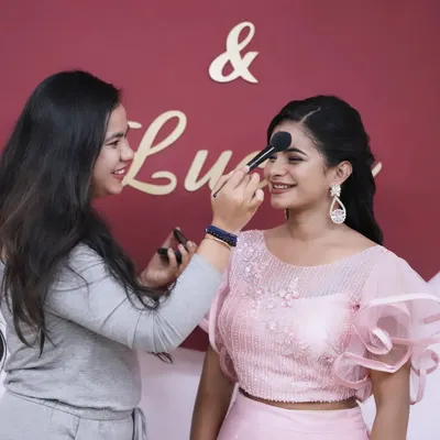Behind the scenes of a creative shoot. This image shows me in my element, applying makeup to a model for a portfolio project.