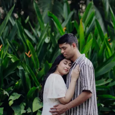 A peaceful embrace, surrounded by lush greenery. This is what it looks like to feel at home in someone's arms.