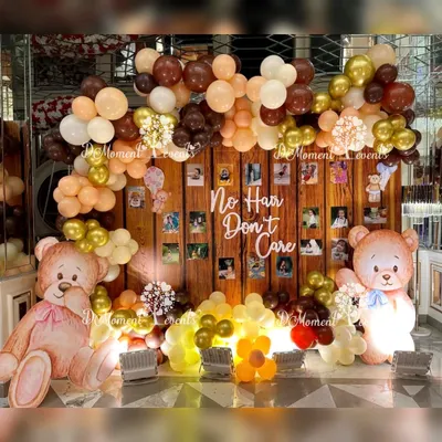 A fun and heartwarming photo wall for a Mundan ceremony. The "No Hair Don't Care" sign adds a playful touch to the teddy bear theme, which features a wood-panel backdrop and earthy-toned balloons.