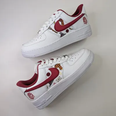 A custom pair of Gryffindor-themed Air Force 1s, featuring various motifs from the Harry Potter world like the sorting hat, a broomstick, and even Dobby.