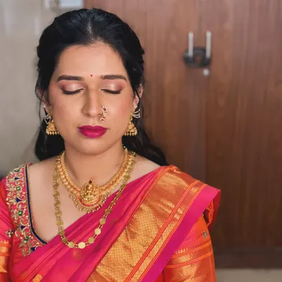 For Anusha's engagement, we created this beautiful look with a focus on shimmering pink eyeshadow and a matching bold lip.