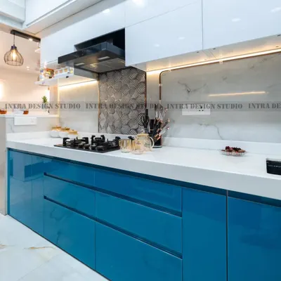 A close-up of the high-gloss blue acrylic drawers in our Delta 2 project. The handleless design and flawless finish contribute to the kitchen's ultra-modern and clean aesthetic.