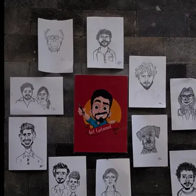 Here's a look at some of my work displayed on a wall. It shows the variety of faces I get to draw, from solo portraits and couples to even a cute puppy, all done in my signature hand drawn style.
