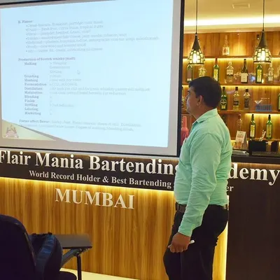 An instructor leads a theory class at our Mumbai academy. Our well-equipped classrooms and fully stocked bars provide the perfect learning environment.
