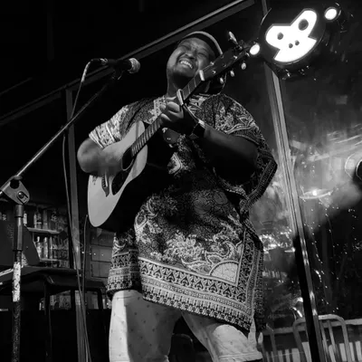It's all about the feels. A black and white shot from an intimate acoustic gig, capturing the pure joy of just playing and singing.