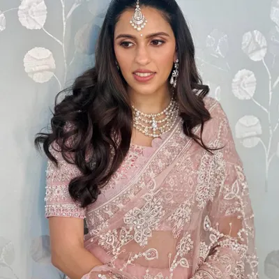 This beautiful pink Abu Jani Sandeep Khosla saree with intricate white embroidery is the epitome of grace. It's a perfect choice for a wedding guest who wants to look elegant and sophisticated.