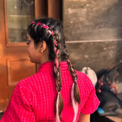 A back view of our festival braids, weaving in pink and white extensions for a fun, temporary pop of color.