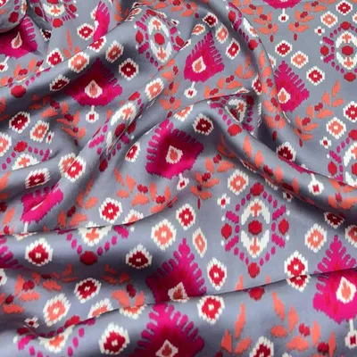 Sleek, soft, and sophisticated. This printed modal satin with a vibrant ikat-inspired design has a beautiful drape that's perfect for creating everything from a saree to a stylish co-ord set.