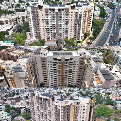 An aerial view of a large apartment building in Bengaluru fitted with rooftop solar panels by EcoSoch Solar, showing the integration of green energy in urban settings.
