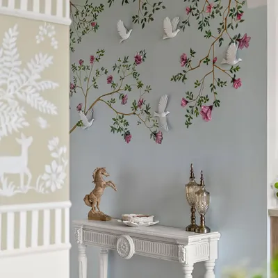 It’s corners like these that create a true sense of calm and belonging. This foyer isn’t just an entryway; it’s a warm embrace, with its hand-painted mural and elegant console table.