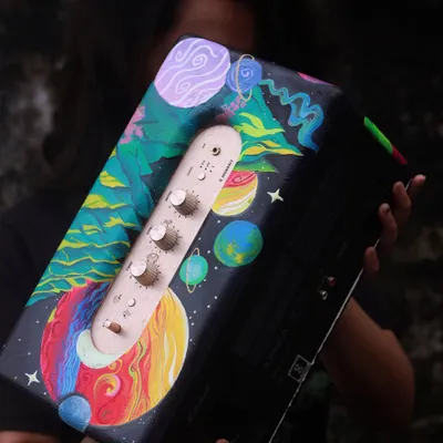 Here I am with the finished custom Marshall speaker. I painted a surreal, dreamy galaxy scene that wraps around the whole speaker. It's a functional piece of art that will definitely be a conversation starter.