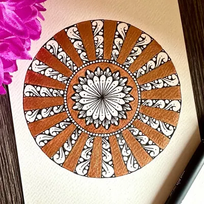 Sparkling with positivity, this mini mandala combines classic black and white patterns with a beautiful metallic bronze. The contrast creates a warm, radiant effect.