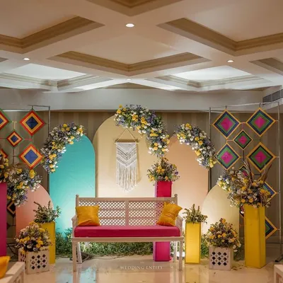 A truly Insta-worthy Mehendi backdrop. I used a mix of geometric patterns, pastel-colored arches, and a central macrame piece to create a modern, bohemian vibe for the bride's seating.