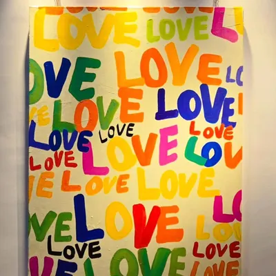 Spread the love with a hand-painted typography piece. This vibrant "LOVE" painting is a perfect gift or a cheerful addition to a bedroom, adding a pop of color and a positive message.