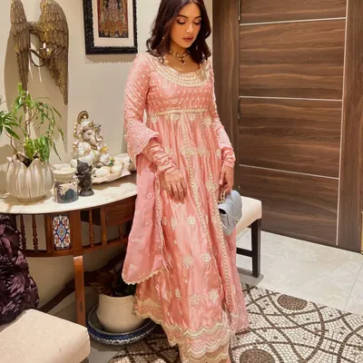 Bhumi Pednekar celebrating Ganpati in a lovely pink Anarkali suit. This is a perfect example of a classic, festive look that is both comfortable and chic.