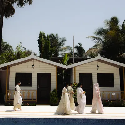 A wide shot of the venue for an intimate Nikaah, showing guests by the pool. This photo sets the scene for a relaxed and beautiful celebration.
