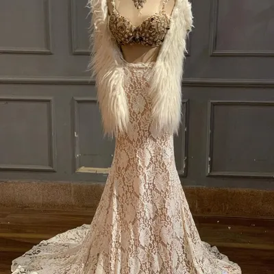 New in. This ivory lace lehenga with a heavily embellished bustier and a faux fur shrug is the definition of Indo-Western glam.