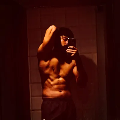A shirtless mirror selfie showing a defined six-pack and upper body. The result of clean eating and hard training.