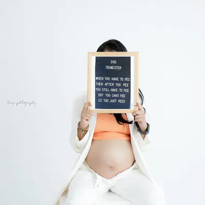 A fun and relatable take on the third trimester. This creative shot with a letter board adds a touch of humor and personality to the maternity session.