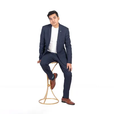 A classic corporate headshot for professionals. The subject is dressed in a smart blazer and seated against a clean white background, creating a sharp and polished image for business use.
