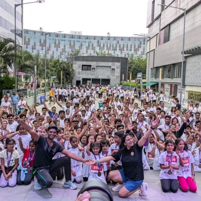 A sea of smiling faces and raised hands. This is the view from the stage at the "Run for Happiness" marathon, where we led a massive crowd in a pre-run Zumba warm-up session.