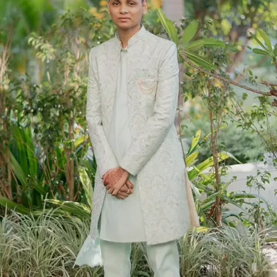 A light and airy outfit for a daytime event. This is a light pista-colored koul kurta with a matching open Indo-Western jacket featuring subtle embroidery, paired with pista pants.