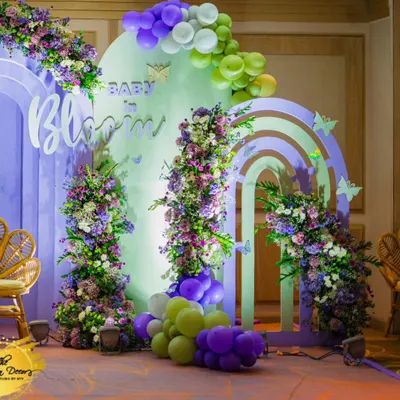 A gorgeous "Baby in Bloom" backdrop for a memorable baby shower. I used a palette of pastel purple, green, and white, with beautiful floral arrangements and balloon garlands to create this dreamy photo corner.