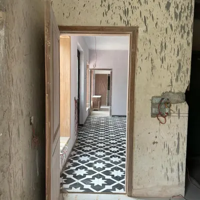 This is where it all begins. A raw site, with unfinished walls and floors, holds all the potential for what's to come. This home needed love, and this image captures the very start of its transformation journey.