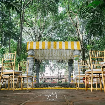 I transformed Angana the Courtyard into a temple of love with this stunning mandap. The stone pillars are adorned with vibrant marigolds and chrysanthemums, creating a timeless and elegant setting for the ceremony.