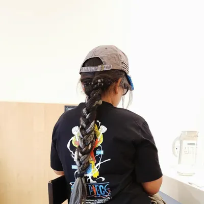 For this client, I styled her long, dark dreadlocks into a single, thick braid. This is a beautiful and functional protective style that keeps locs neat and tidy while looking incredibly chic.