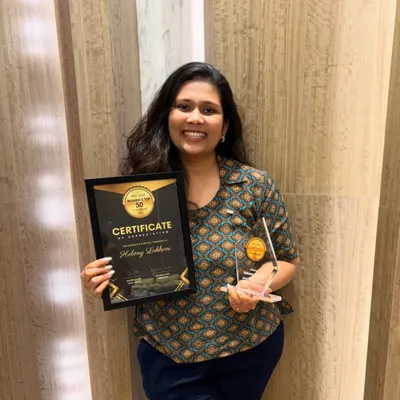 A proud moment holding my "Top 50 Mumbai Bakers" award and certificate. This recognition means so much and fuels my passion to keep baking and teaching.